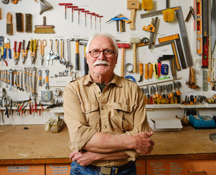 man standing in front of workshop bench