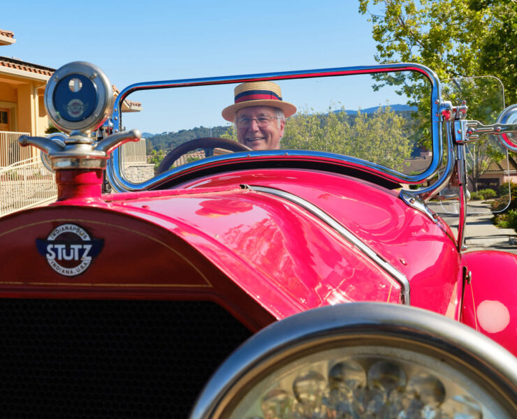man driving antique car