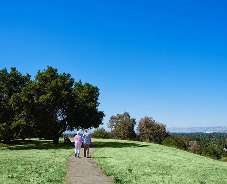 A senior couple walking a trail