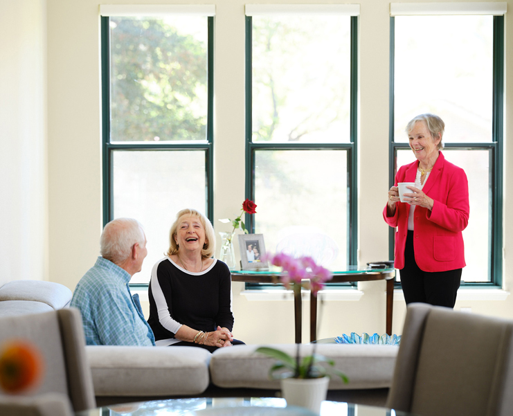 Seniors gather in a meeting area with coffee