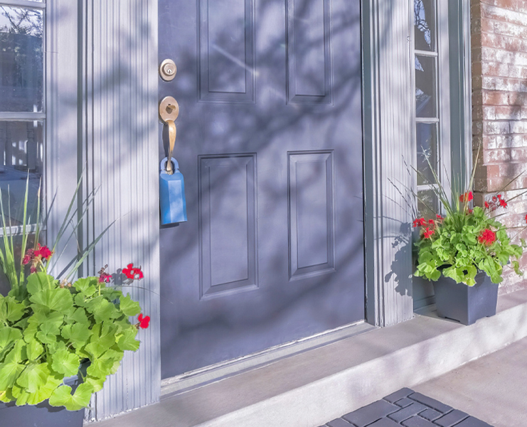 A front door of a home with a lock box on it